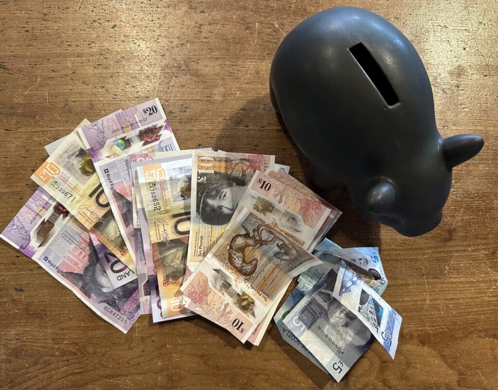 Piggy Bank with Scottish notes and coins How can an ISA save you £70000 in tax