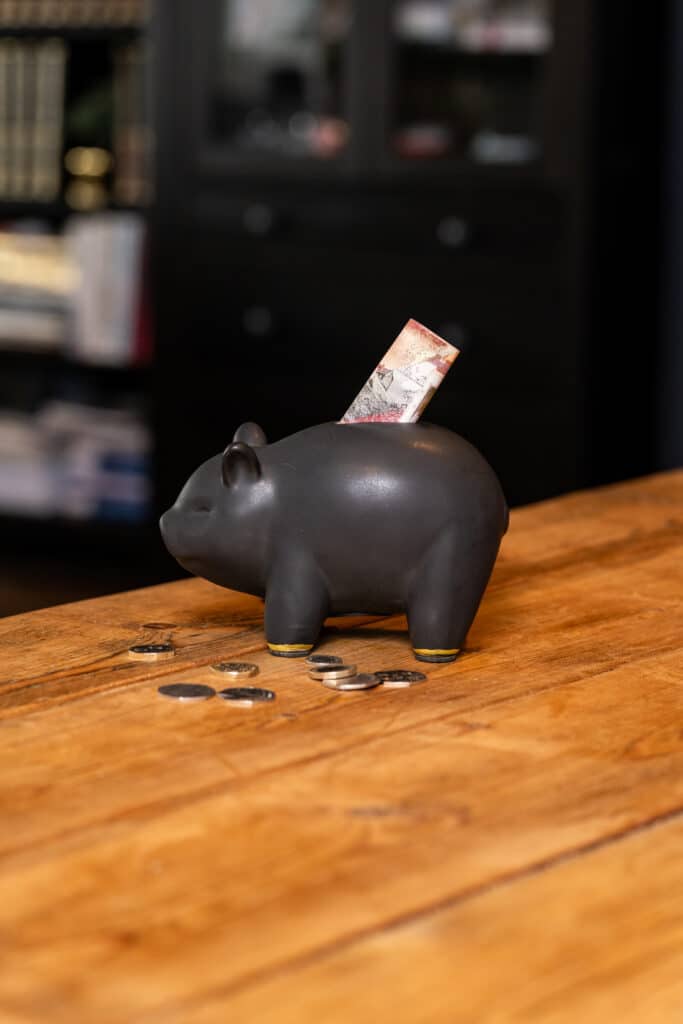 Piggy bank with money being added Best Savings Accounts & Interest Rates in 2026: Where to Position Your Cash as Interest Rates Fall